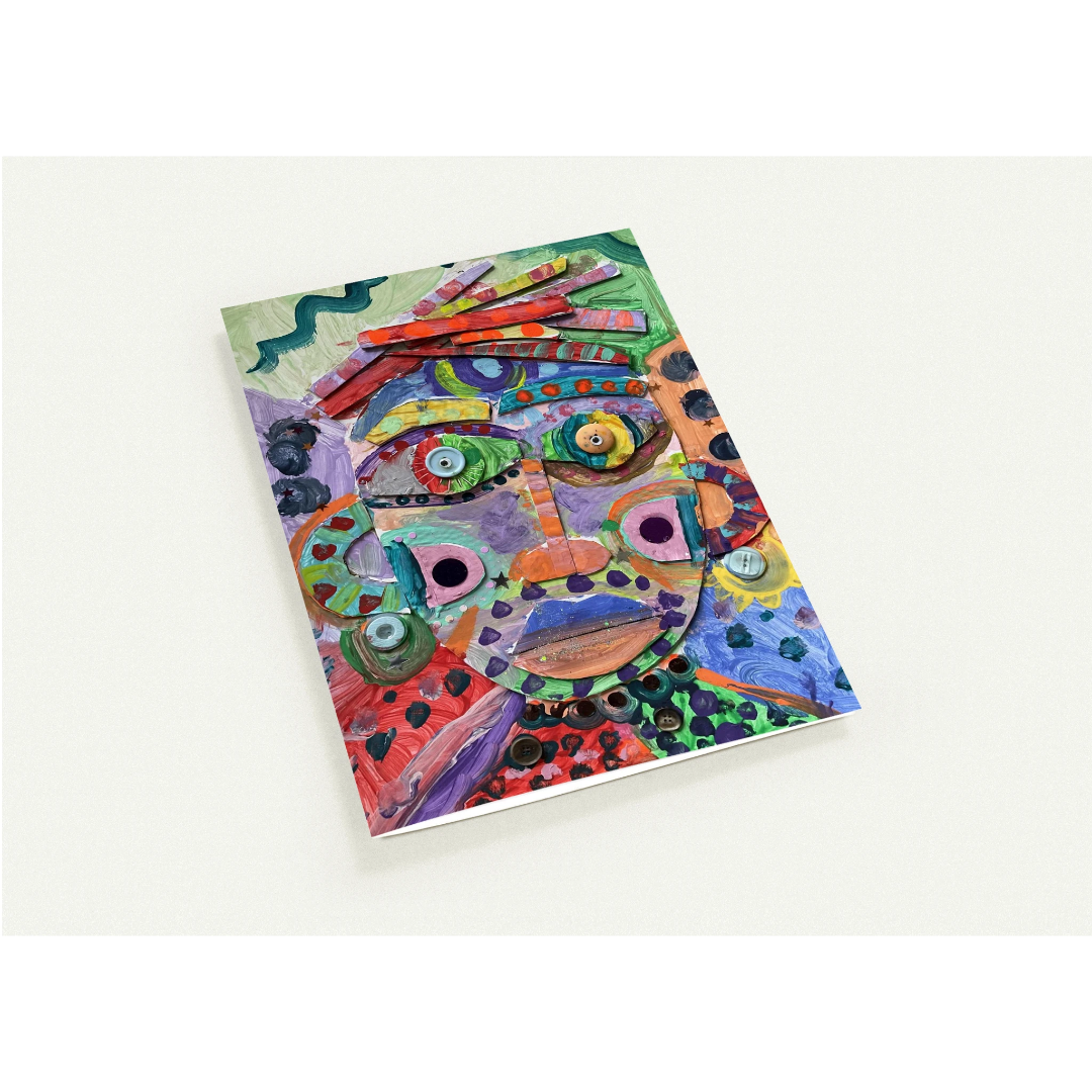 Colorful abstract face design on a notebook cover against a white background