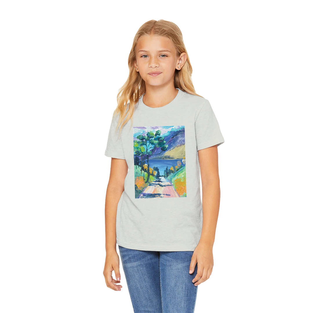 Girl wearing a grey t-shirt with a colorful nature graphic on a white background