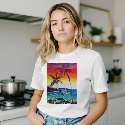 Woman wearing a white t-shirt with a colorful palm tree design in a kitchen.
